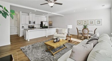 Living room with a ceiling fan, recessed lighting, wood finished floors, and baseboards