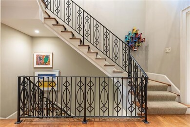 Custom wrought-iron banister and sophisticated continuous staircase