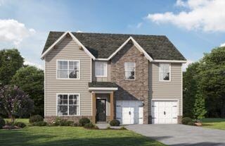 Traditional-style house with asphalt driveway, an attached garage, and a front lawn