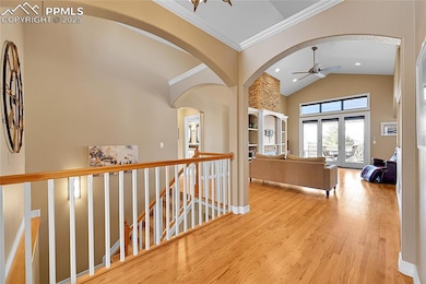 Hall with a main-level landing, ornamental molding
