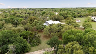 Birds eye view of property featuring a wooded view