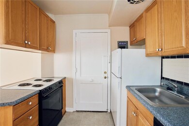 Kitchen with electric range oven, a sink, crown mo