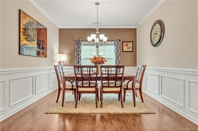 Beautiful dining room with moldings and accent wal