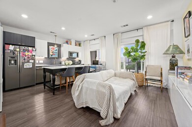 Living area with recessed lighting, dark wood-sty