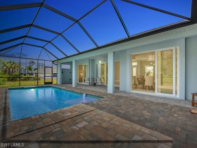 View of swimming pool with glass enclosure and a p
