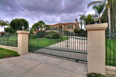 There is a circular driveway with 2 gates for adde