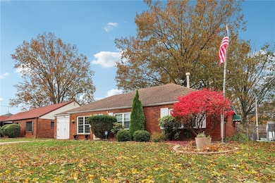 View of front of house featuring brick siding and a shingled roof