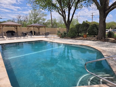Community pool featuring a gazebo and a patio area