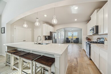 This bright kitchen features modern white cabinetr