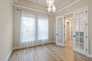 The home office features a beautiful light fixture