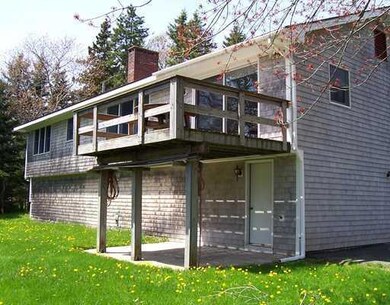 Exterior Back. Deck and patio with...