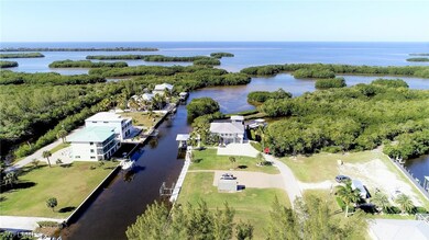 View lookikng down at the home with Boat lift, tre