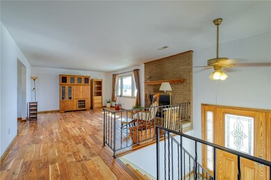 A light, bright entry leads to gorgeous hardwood f