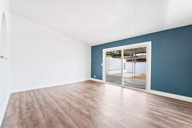 Empty room with wood finished floors, baseboards,