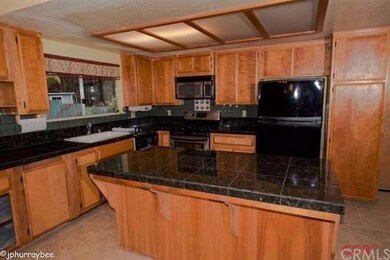 Remodeled kitchen with granite tiles and stainless