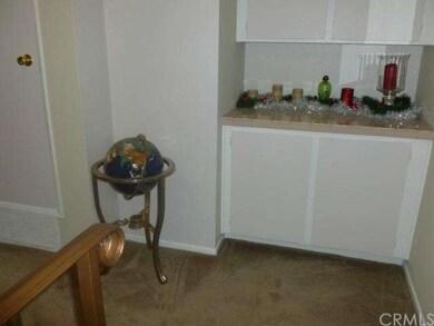 Top of stairway; cabinets for extra storage.