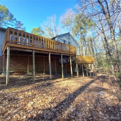 Rear view of house with a wooden deck