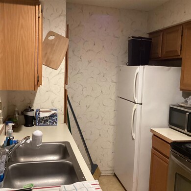 Kitchen with light countertops, stainless steel mi