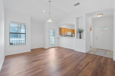 Spacious Living Room and Dining Room with a view into the Kitchen.