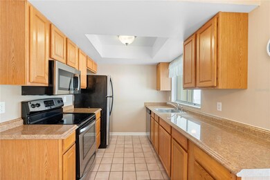 Galley style kitchen with solid wood cabinets and appliances included.