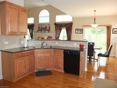 Open kitchen with tile backsplash.