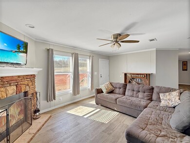 Living room featuring visible vents, baseboards, a