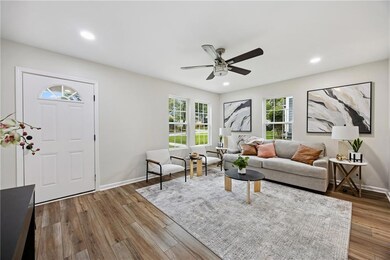 Living area featuring a ceiling fan, wood finished floors, and recessed lighting