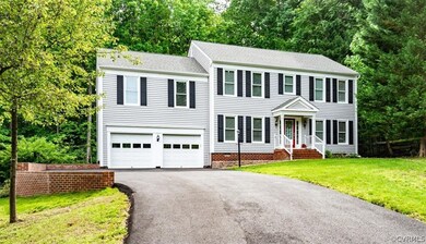 View of front of home with a garage and a front la