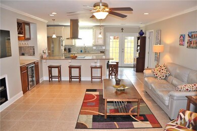 Den w/ mini bar and opens into kitchen