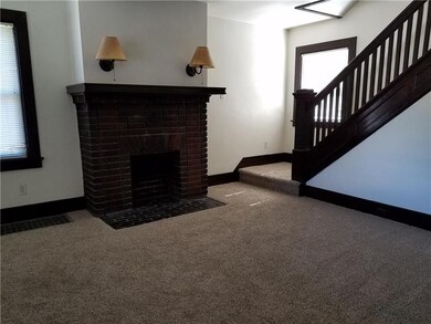Living room features decorative fireplace and orig