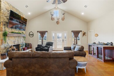 Living room featuring high vaulted ceiling, a weal