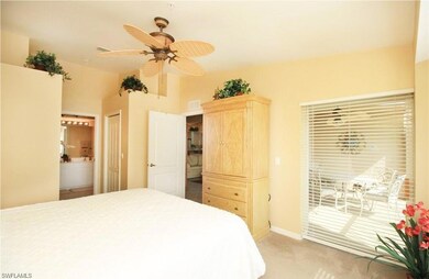 Carpeted bedroom with connected bathroom, access to exterior, ceiling fan, and a closet