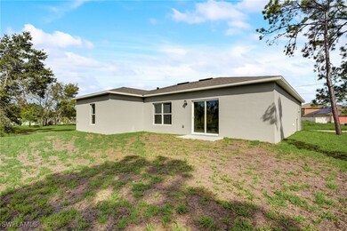 Back of house with a yard