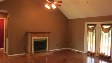 Living room features a fireplace and cathedral ceilings