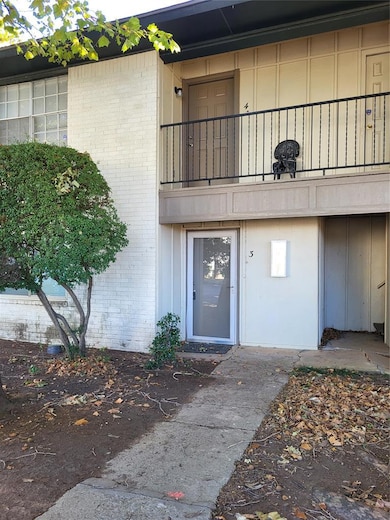 Doorway to property with brick siding and board and batten siding