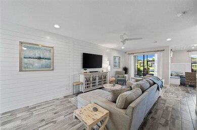 Living room with ceiling fan and wooden walls
