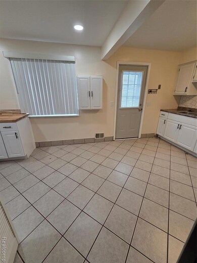 Unfurnished dining area featuring light tile patterned flooring and recessed lighting