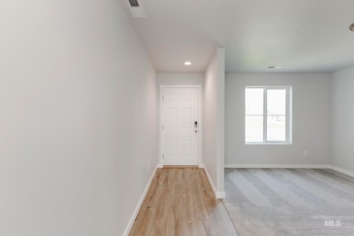 Hallway with recessed lighting and light wood-style flooring