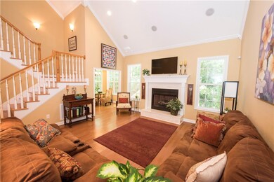 Living Room with gas logs fireplace and vaulted ce
