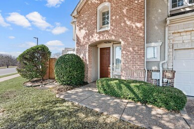 View of exterior entry featuring a garage, brick s