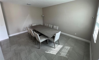 Formal dining room with 8-seat table included in rental or formal living room.