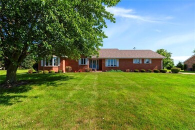 Ranch-style home featuring a front yard and brick siding