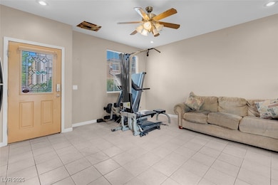 Exercise area with baseboards, a ceiling fan, a he