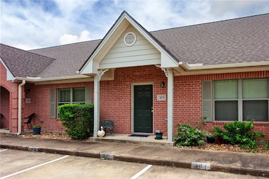 Entrance to property with brick siding, roof with