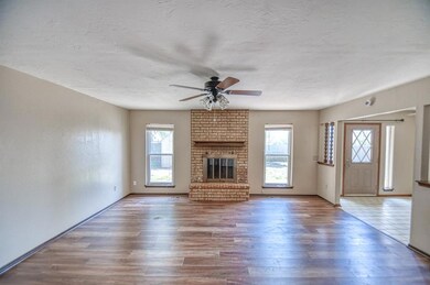 Unfurnished living room featuring a fireplace, har