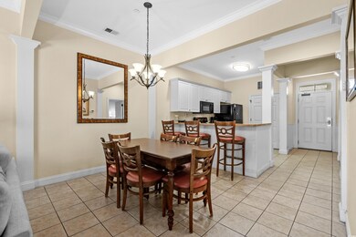 Tiled dining room featuring ornamental molding, de