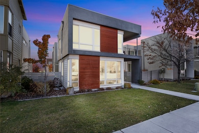 Contemporary house featuring a balcony and stucco siding
