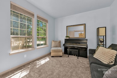Living area featuring carpet flooring and baseboards
