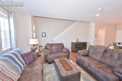 Living room showing front door entry and stairs to