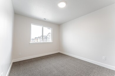 Empty room featuring carpet floors and a textured ceiling